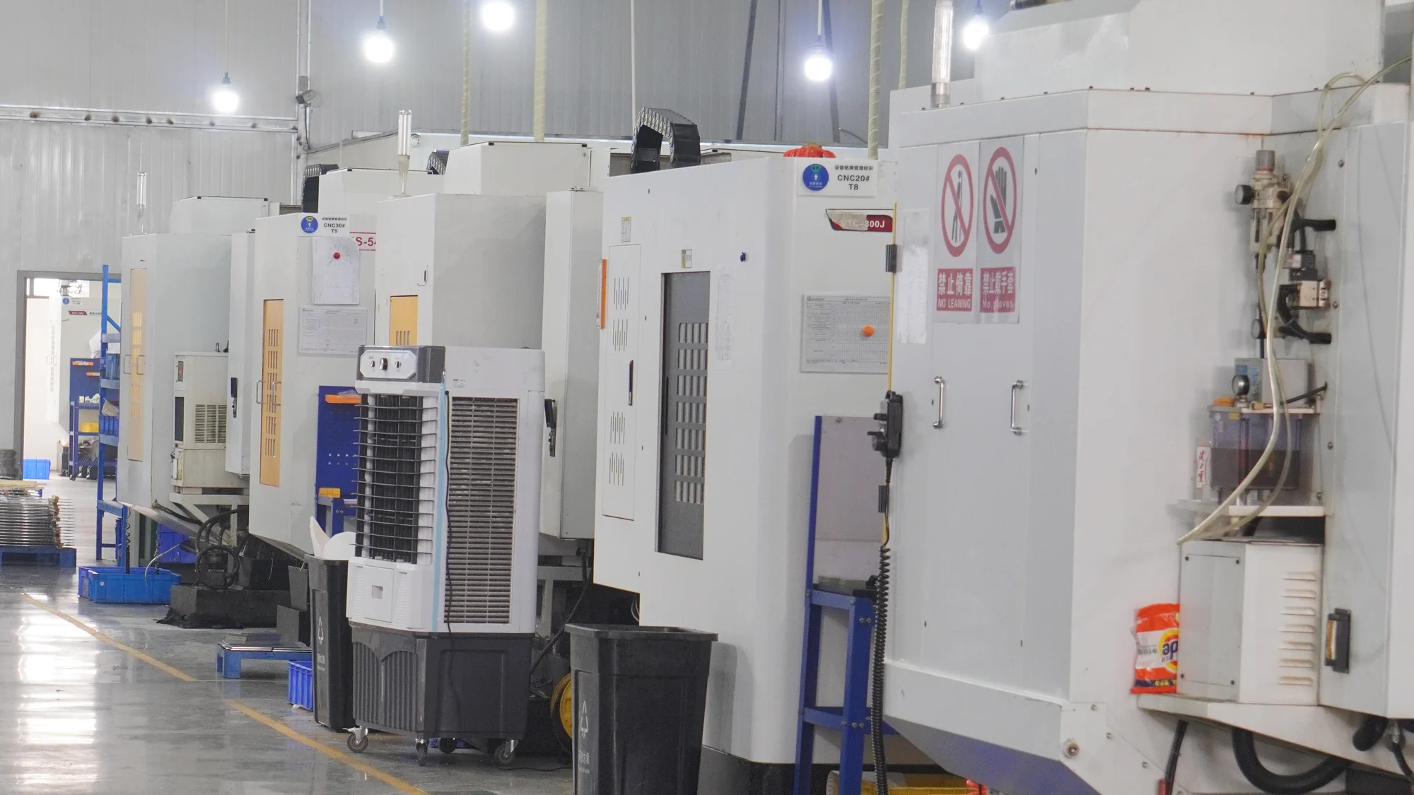 A row of CNC machining centers in the ForgePlus workshop